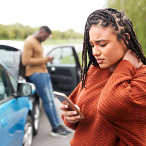 Woman holding her neck after an accident, symbolizing personal injury