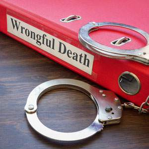 Red binder labeled 'Wrongful Death' with handcuffs symbolizing wrongful death in iowa